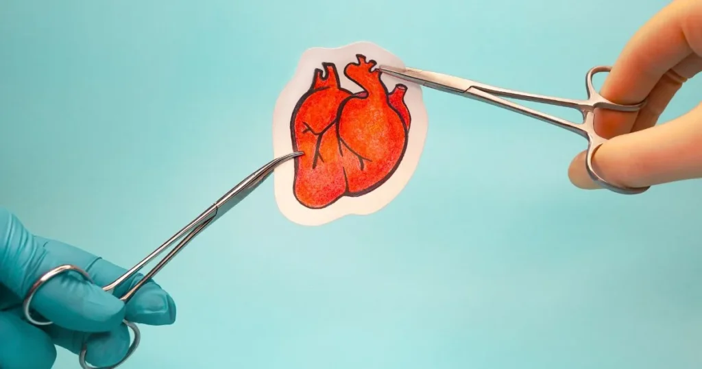 Surgeons holding up a paper heart.