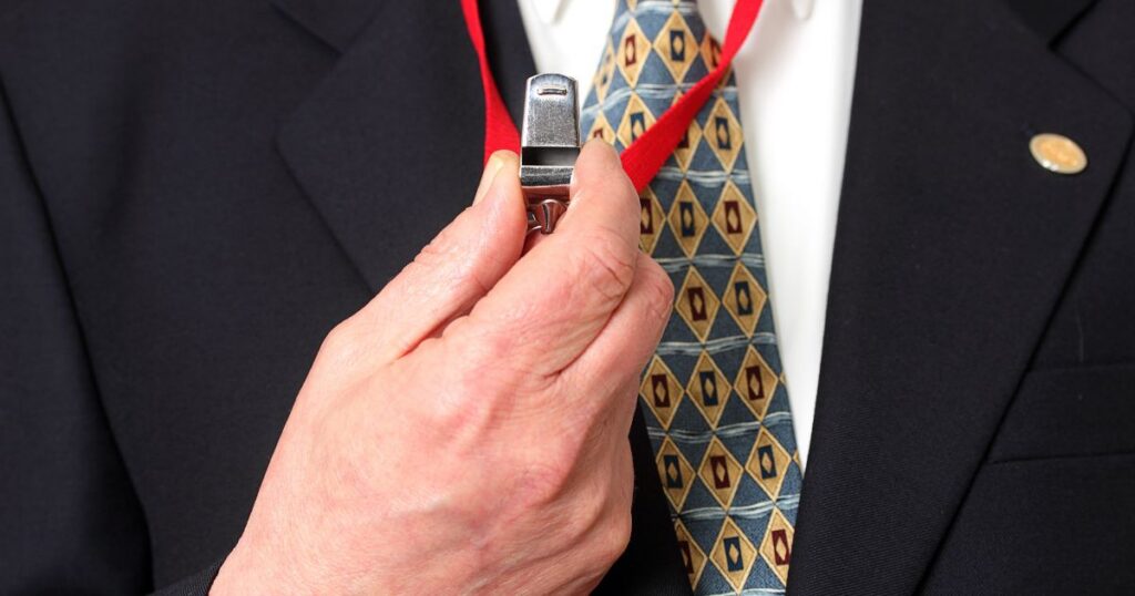 Employee holding a whistle