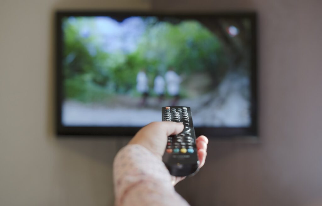TV and hand hold remote control.