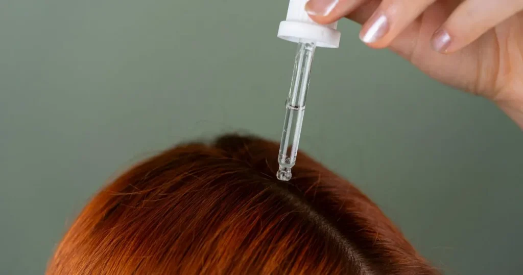Woman putting hair product in her hair