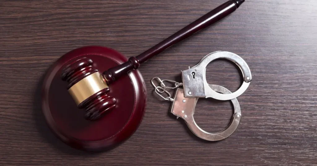 Gavel with handcuffs next to them