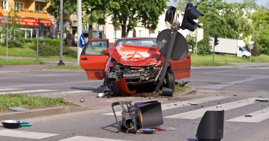 Red car wrecked after crashing into traffic light