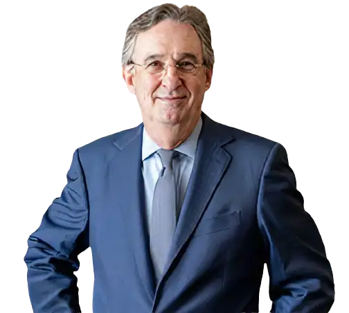 Business professional in a navy suit smiling confidently.