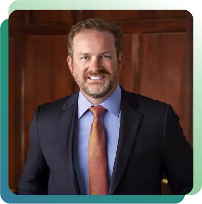 Business professional in a suit smiling, representing leadership and expertise in a professional env.