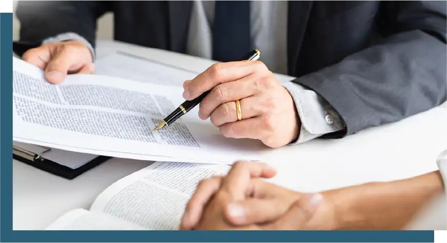 Business professionals reviewing documents during a strategic meeting.