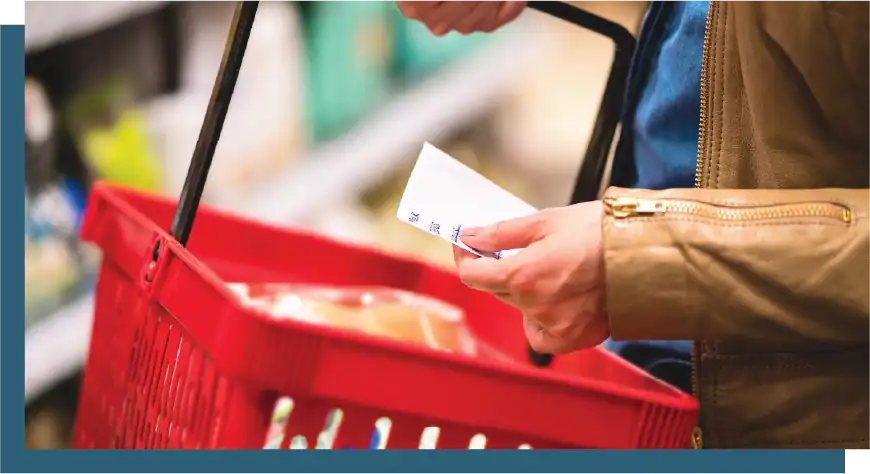 Person checking receipt while shopping at a convenience store.