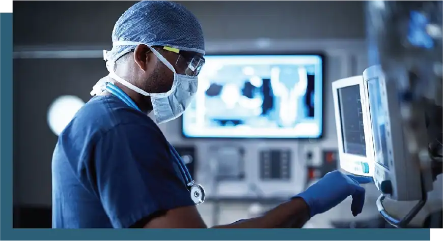Surgeon using medical imaging technology in a clinical environment.