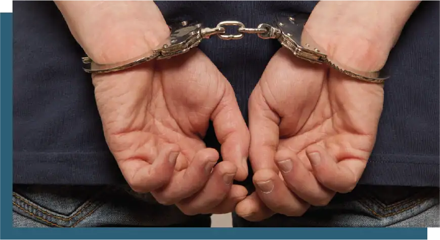 Handcuffed hands, representing law enforcement, legal challenges, or criminal justice.