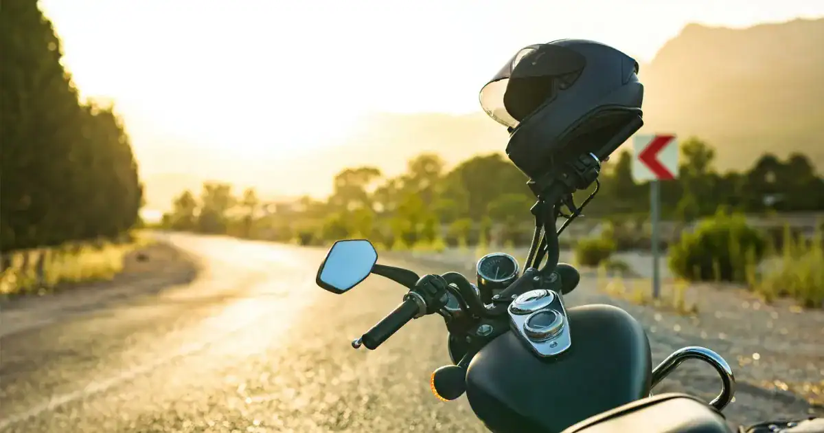 Motorcycle helmet placed on bike handlebar during sunset ride in South Carolina.