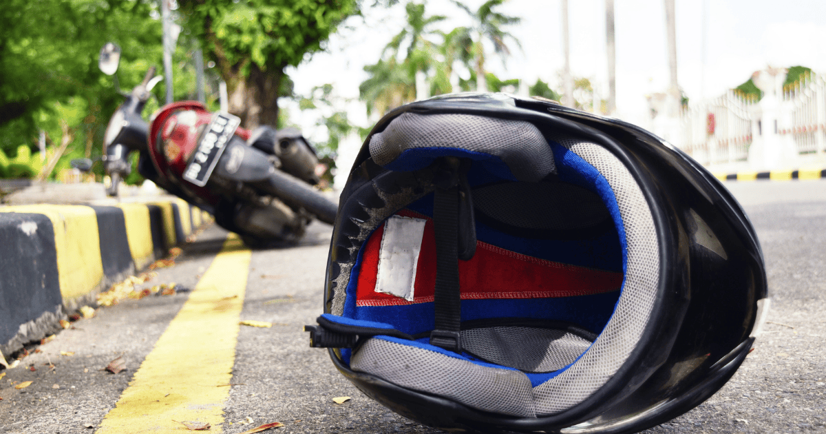 Black motorcycle helmet with blue interior on the street in Charleston.